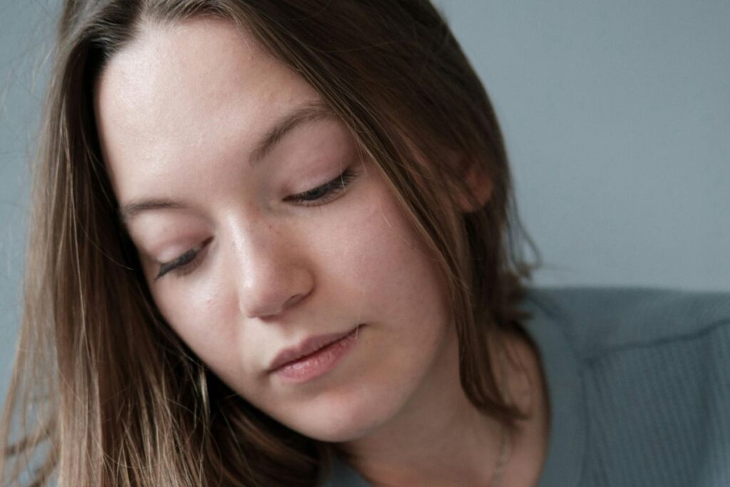 Calm postnatal woman supporting pelvic balance after childbirth